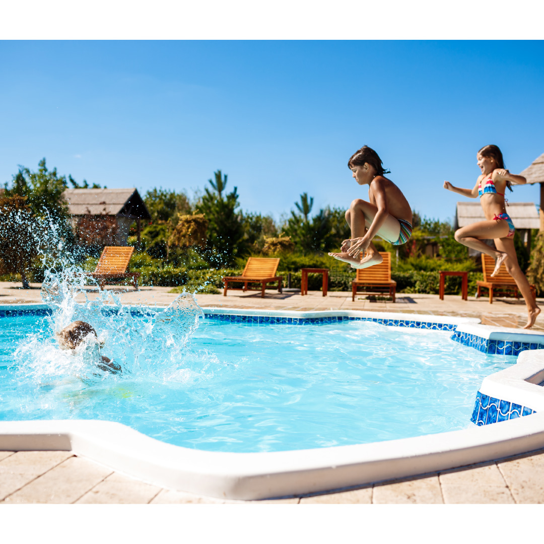 cheerful children rejoicing jumping swimming in pool